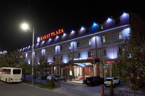 a building with a sign on top of it at night at Rakat Plaza in Tashkent