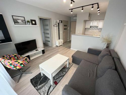 a living room with a couch and a table at Residence Aparthotel in Szczecin