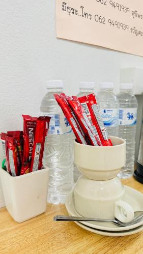 a table with a bowl of chips and bottles of water at Betong 939Homestay in Betong