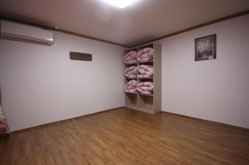a room with a closet with pink donuts in it at Haenam World Pension in Haenam