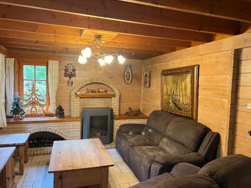 a living room with a couch and a fireplace at De Reinakker Bungalow in Sint-Gillis-Waas