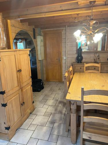 a dining room with a wooden table and chairs at De Reinakker Bungalow in Sint-Gillis-Waas