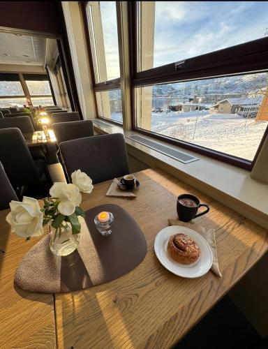 a table with a plate of food on top of it at Hotell Maritim Skjervoy in Skjervøy