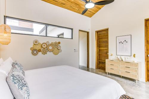 a white bedroom with a large bed and a window at Villa Laguna at Beyond the Blue in Seine Bight Village