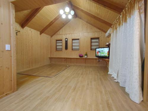a large room with a dance floor and a tv at Danyang mulgoeul pension in Danyang