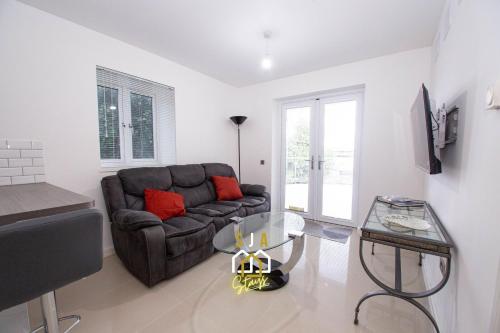 a living room with a couch and a glass table at Affleck Retreat 4 - SJA Stays - Modern 1 Bed Apartment in Aberdeen