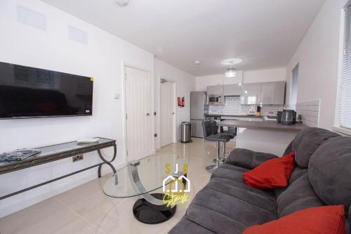 a living room with a couch and a glass table at Affleck Retreat 4 - SJA Stays - Modern 1 Bed Apartment in Aberdeen