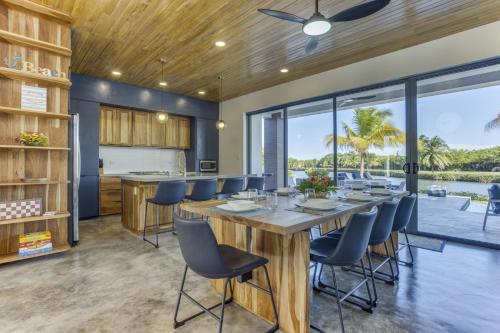a dining room with a large wooden table and chairs at Villa Cascada at Beyond the Blue in Seine Bight Village