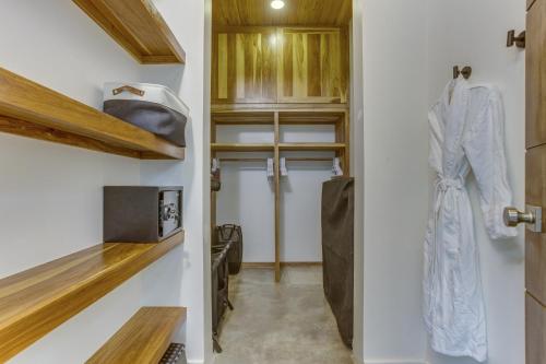 a kitchen with white walls and wooden cabinets at Villa Cascada at Beyond the Blue in Seine Bight Village