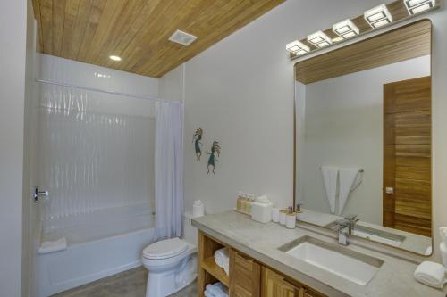 a bathroom with a sink and a tub and a toilet at Villa Cascada at Beyond the Blue in Seine Bight Village