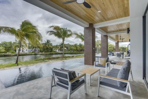an outdoor patio with chairs and a view of the water at Villa Cascada at Beyond the Blue in Seine Bight Village
