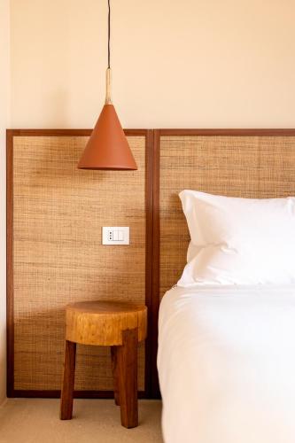 a bedroom with a bed and a table next to a bed at Botanico Villa & Suites in Specchiolla 