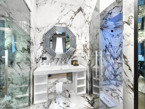 a bathroom with a sink and a mirror at The Plein Hotel - Small Luxury Hotels of the World in Milan