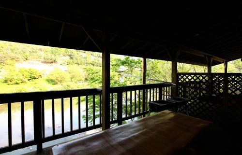 a view from the inside of a porch with a bench at Cheongju Okhwadaestory Pension in Cheongju