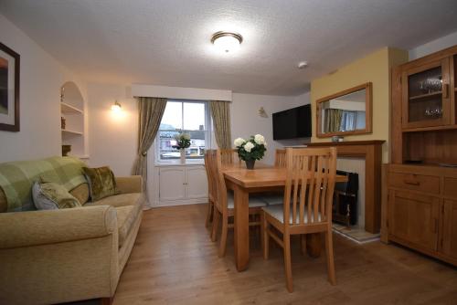 a living room with a table and a couch at Duke's House, Penrith - Stunning Large Home - Town Centre on your Doorstep - 5 Bedrooms & Sun Trap Garden - Lake District Stay in Penrith