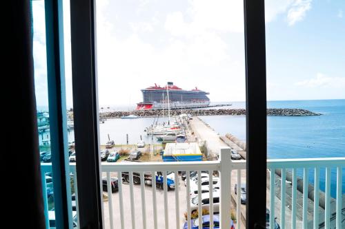 a view of a cruise ship from a balcony at Kings Pavilion Suites Hotel in Basse Terre Town