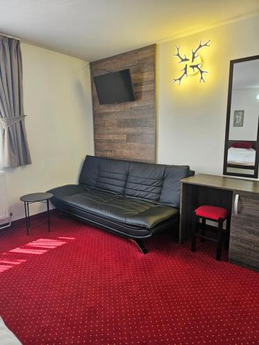 a living room with a couch and a table at Pensiunea Miruna in Moieciu de Jos