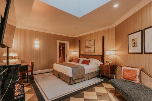 a hotel room with a bed and a couch at Wellington Hotel & Spa Madrid in Madrid