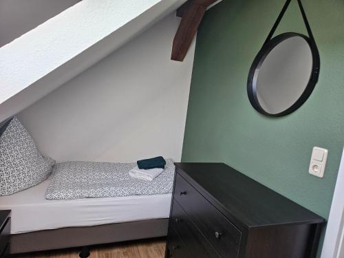 a bedroom with a bed and a mirror on the wall at Ferienwohnung Forsthaus in Willingen