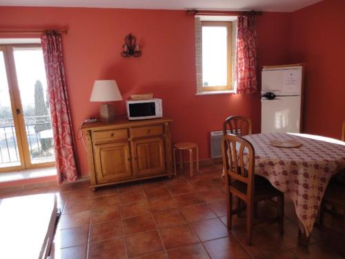 une salle à manger avec une table et un four micro-ondes dans l'établissement Studio cosy au cœur des lavandes, piscine, proche Village - FR-1-822-5, à Brunet
