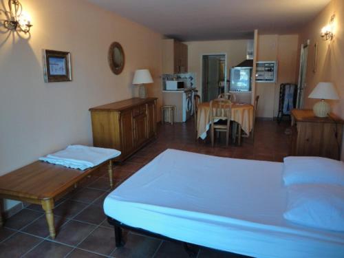 une chambre avec un lit et un salon dans l'établissement Studio cosy avec piscine au cœur du plateau de Valensole - FR-1-822-13, à Brunet