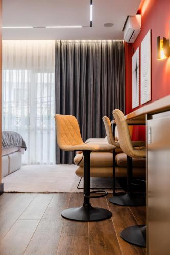 a living room with a table and chairs at AL Apartments Tirana in Tirana