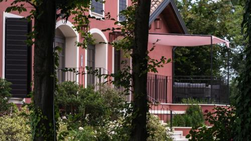 a pink house with trees in front of it at Alle Siepi in Reggio Emilia