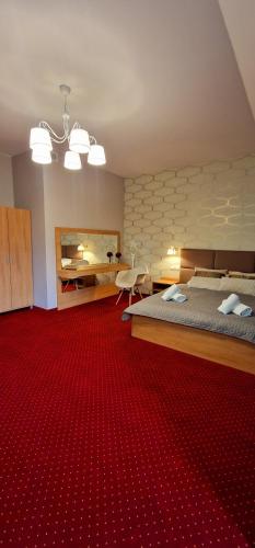 a room with two beds and a red carpet at Szafranowy Dwór in Strawczyn