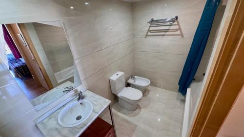 a small bathroom with a toilet and a sink at Vilamar VyB in Denia