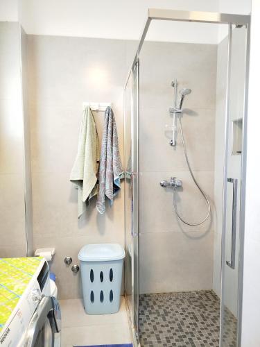 a bathroom with a shower and a toilet at Large Apartment - Perla Resort, Gjiri i Lalezit in Draç
