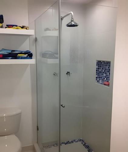 a glass shower in a bathroom with a toilet at South End Villas - Colombian Caribbean Apartments in San Andrés