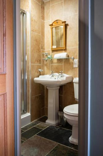 a bathroom with a sink and a toilet at Tottington Manor Hotel in Henfield