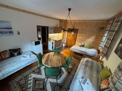 a living room with a table and a kitchen at Gasthof Frasswirt in Frass