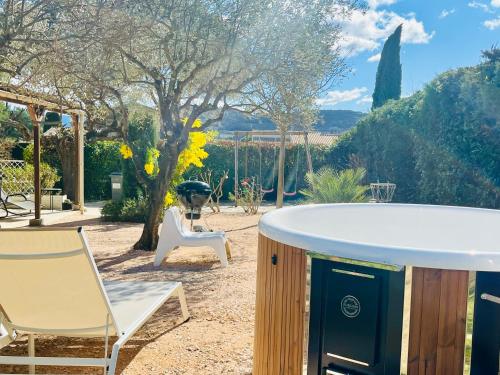 a hot tub and two chairs in a yard at House with nice garden, downtown by walk in Vaison-la-Romaine