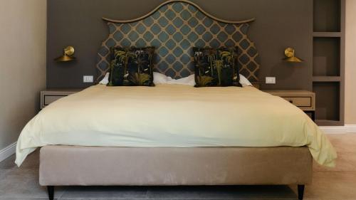 a bedroom with a large bed with a large headboard at Alle Siepi in Reggio Emilia