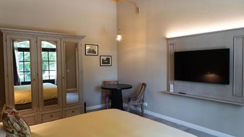 a room with a tv and a bed and a table at Alle Siepi in Reggio Emilia