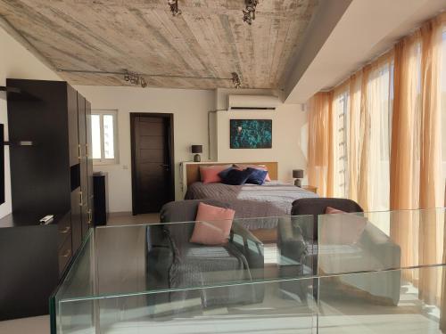a bedroom with a bed and a glass table at Xlendistays - Centrally located Seafront living holiday spaces in Xlendi in Xlendi