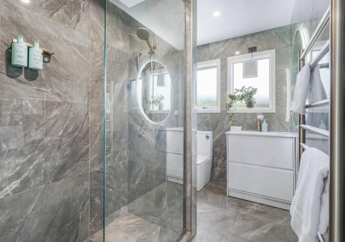 a bathroom with a shower and a sink at Walk to the City Centre! Stylish & Modern #1 -By KOSH BNB in Hamilton