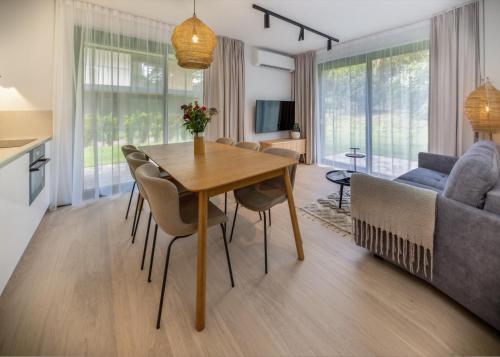 a living room with a table and a couch at Apartamenty na Półwyspie Wydma&Las in Jastarnia
