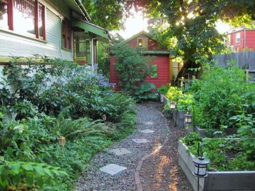 a garden in front of a house with plants at Charming Garden Cottage in Eugene