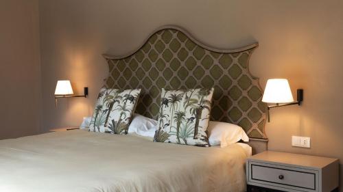 a bedroom with a large bed with two pillows at Alle Siepi in Reggio Emilia