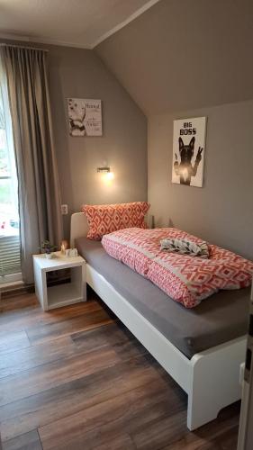 a bedroom with a large bed and a window at Glücksburg Strandnah an der Förde in Glücksburg