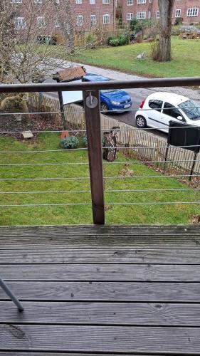 a table on top of a wooden deck with a yard at Glücksburg Strandnah an der Förde in Glücksburg