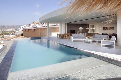 a swimming pool on the roof of a house at Exclusiv one in Torrox