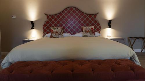 a bedroom with a large bed with a red headboard at Alle Siepi in Reggio Emilia