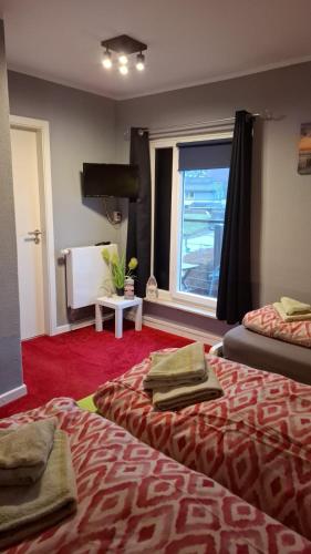 a hotel room with two beds and a window at Glücksburg Strandnah an der Förde in Glücksburg