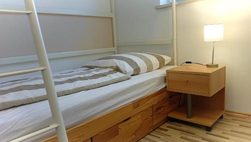 a bedroom with a bunk bed and a night stand at Ferienwohnung Pinzenhof - Kemnath in Kemnath