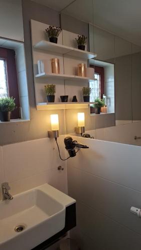 a bathroom with a sink and a mirror at Glücksburg Strandnah an der Förde in Glücksburg