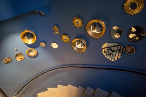 a hallway with many different lights on a blue wall at Casual Eclettico Milano in Milan