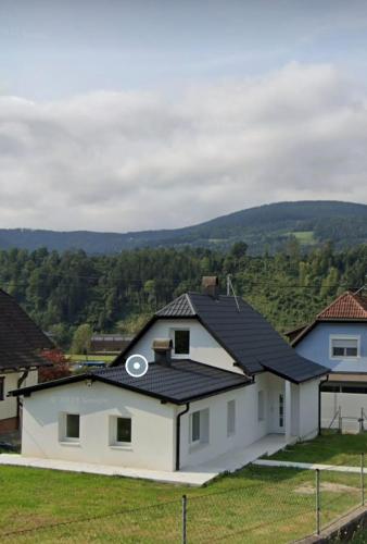 a white house with a black roof at Villa- SARA in Lavamünd